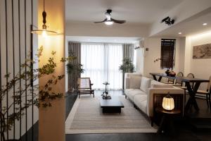 a living room with a couch and a table at XiangNanLi Atelier Suites-Chengdu Chunxi Road & Taikoo Li in Chengdu