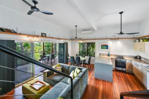 a kitchen and living room with a couch and a table at 1770 Horizons holiday house - pet friendly home in 1770 in Seventeen Seventy