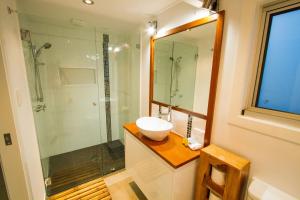 a bathroom with a sink and a glass shower at 1770 Horizons holiday house - pet friendly home in 1770 in Seventeen Seventy +12 photos