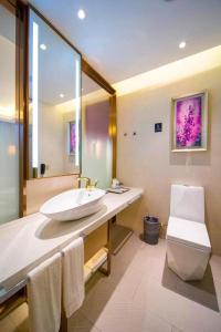 a bathroom with a sink and a toilet at Lavande Hotel Yangzhou Railway Station Jiangwang RT-Mart in Yinjiahu