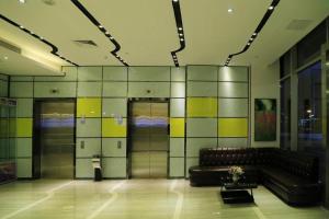 a lobby with a leather couch in a building at Lavande Hotels Suzhou Railway Station in Suzhou