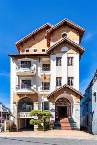 a large building with stairs in front of it at Hung Phong Hotel - Near Dalat Night Market in Da Lat