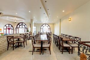 a dining room with wooden tables and chairs at Hung Phong Hotel - Near Dalat Night Market in Da Lat