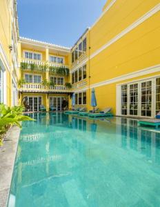 a large swimming pool in a large building at TRIPLE Riverside Villa Hotel HoiAn in Hoi An