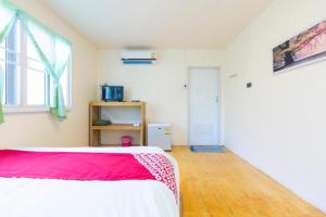 - une chambre dotée d'un lit avec une couverture rouge et blanche dans l'établissement OYO 75359 Thaiburi Thara Resort, à Ban Yan Chao