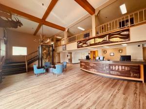 an empty lobby with blue chairs and a bar at Wingate by Wyndham Anchorage Downtown - Ship Creek in Anchorage
