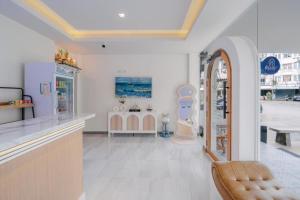 a store with a counter and a chair in a room at Blue rabbit phuket in Ban Tha Khreng