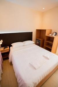 a bedroom with a large white bed in a room at JVJ HOTEL in Batangas City +11 photos