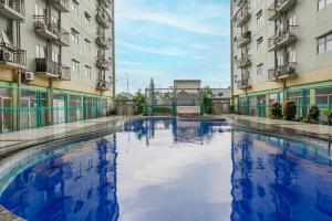 a pool of water between two buildings at OYO 94150 Gateway Apartment Pasteur By Eldian in Bandung +33 photos