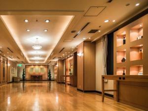 a large lobby with a reception desk in a building at Nagoya Sakae Tokyu REI Hotel in Nagoya