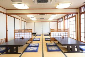 a room with two tables and blue mats on the floor at Hotel Hokke Club Kumamoto in Kumamoto +161 photos