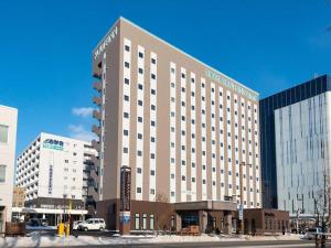 a large hotel building in the middle of a street at Hotel Route Inn Grand Kitami Ekimae in Kitami