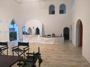 a large white room with chairs and a table at Amaravati Wellness Center in Ban Muang Pha