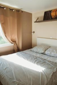 Ένα ή περισσότερα κρεβάτια σε δωμάτιο στο Mobilhome Mare e Monte