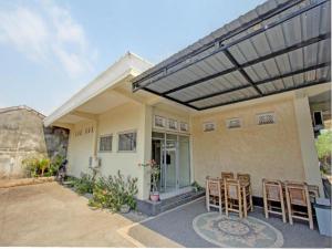 un groupe de chaises assises à l'extérieur d'une maison dans l'établissement Capital O 93124 Lombok Northis Homestay, à Paloh