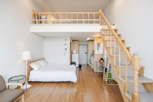 a bedroom with a bunk bed and a staircase at JSM Studio Hongdae in Seoul