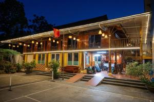 a house with a flag on it at night at Tien Tour & Homestay in Bản Kin