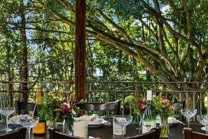 a table with wine glasses and flowers on it at Meadows House & Events in Bangalow