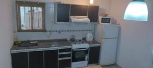 a small kitchen with a sink and a refrigerator at ALBERTI APARTAMENTS in Campana
