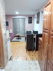 a kitchen and living room with a couch and a table at Simic Apartmani Tara in Kaludjerske Bare