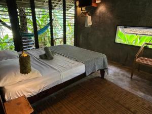 a bedroom with a bed in a room with a window at LOA Stay in Surigao
