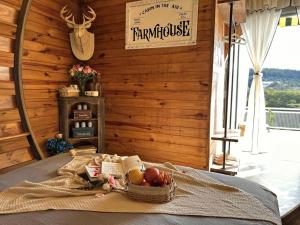a basket of fruit on a bed in a room at Cabin In The Air in Ấp Ða Lợi +50 photos
