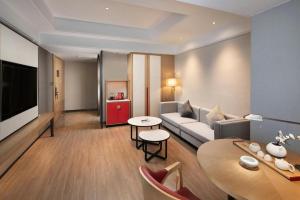 a living room with a couch and a table at E-Cheng Hotel Shenyang North Railway Station in Shenyang