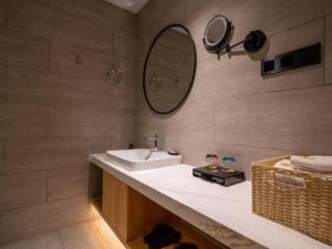 a bathroom with a sink and a mirror at Immersing Hotels & Resort Yunzhu Meiyuan Wuyishan Impression Dahongpao in Wuyishan +182 photos
