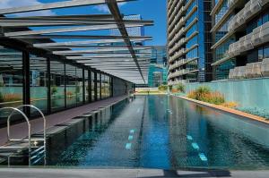 a swimming pool on the side of a building at 2Br2B1Ba Spacious apt with free parking Docklands in Melbourne