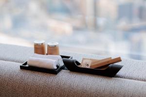 a couple of towels and two cups on a table at Park Hotel Tokyo in Tokyo