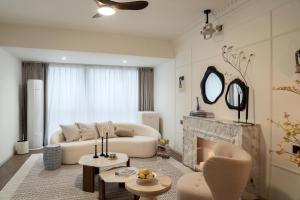 a living room with a couch and a fireplace at XiangNanLi Atelier Suites-Chengdu Chunxi Road & Taikoo Li in Chengdu