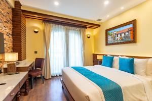 Voodi või voodid majutusasutuse Aarya Hotel and Spa toas