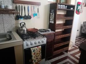 a kitchen with a stove with a pot on it at Ceibos in La Playa Bejarano