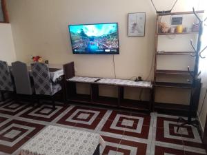 a living room with a flat screen tv on the wall at Ceibos in La Playa Bejarano