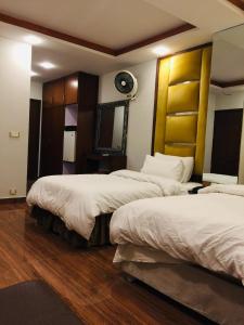 Postel nebo postele na pokoji v ubytování Shanze Hotel And Suites