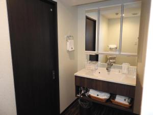 a bathroom with a sink and a mirror at Hotel Bougainvillea Minowa in Tokyo +93 photos