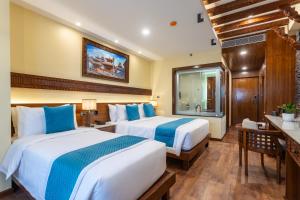 Voodi või voodid majutusasutuse Aarya Hotel and Spa toas
