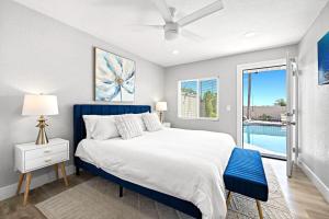 a bedroom with a blue bed and a pool at LUXURY VILLA - SLEEPS 24 - PRIVATE POOL & HOT TUB Beaches Legoland Views! in Vista +163 photos