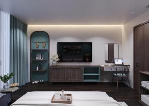 a bedroom with a bed and a desk in a room at Sunrise Mountain View Resort in Vang Vieng