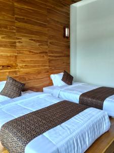 Postel nebo postele na pokoji v ubytování MMMpulukansurfvilla + 17 fotografií