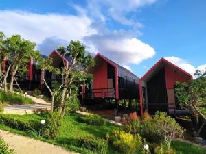 a row of red and black buildings with trees at KATOON RESORT KHAO KHO in Campson