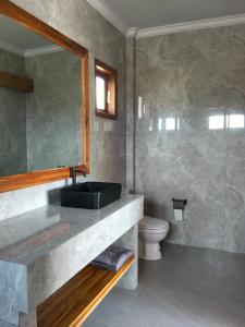 a bathroom with a sink and a toilet at MMMpulukansurfvilla in Medewi +17 photos