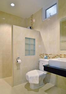 a bathroom with a toilet and a sink at The Rich Resort in Krabi town
