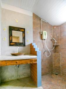 a bathroom with a sink and a mirror at CAPITAL O961 Baan Dow Chompoo Resort in Hua Hin