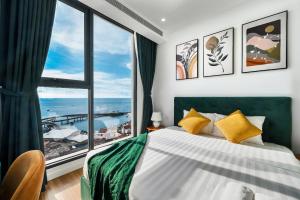 a bedroom with a bed and a large window at Hillside Luxury Phu Quoc Apartment in Phu Quoc +131 photos