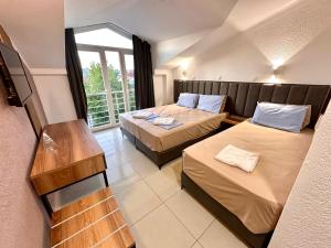a hotel room with two beds and a window at Villa Milka in Ohrid +43 photos