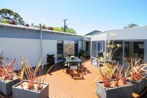 a deck with plants and a table on a house at CeeSpray - Accommodation in Huskisson - Jervis Bay in Huskisson