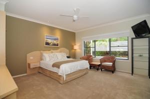 a bedroom with a bed and a flat screen tv at CeeSpray - Accommodation in Huskisson - Jervis Bay in Huskisson