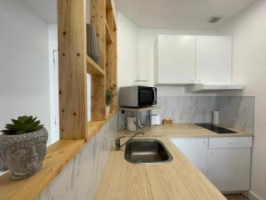 a kitchen with a sink and a counter top at Charmant T2 avec cour extérieure in Cholet