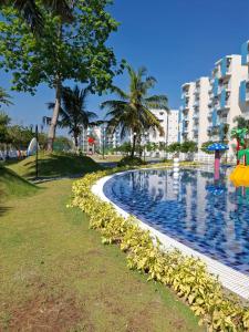 a swimming pool in front of a building at Santorini Apartments 1D F5 U8 in Negombo